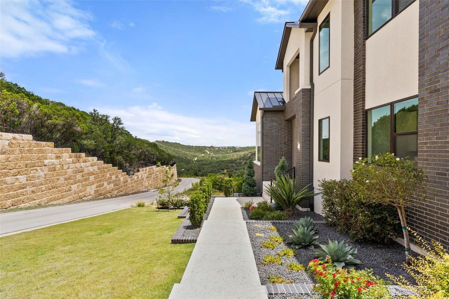 Exterior details and patio area of a home in The Estates at Rough Hollow Vista Ridge, Lakeway (Image 23).