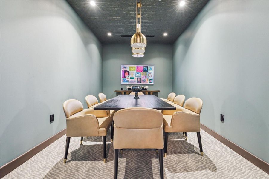 A private dining or conference room within the residents lounge offers a versatile setting for meetings or gatherings, featuring a sleek table, comfortable seating, and a refined, modern ambiance.