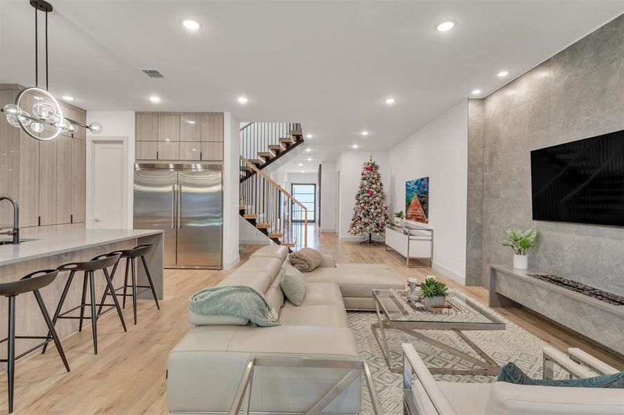 Living room with sink and light wood-type flooring