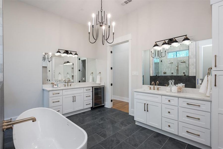 Bathroom with tile patterned floors, double vanity, wine cooler, and a towering ceiling