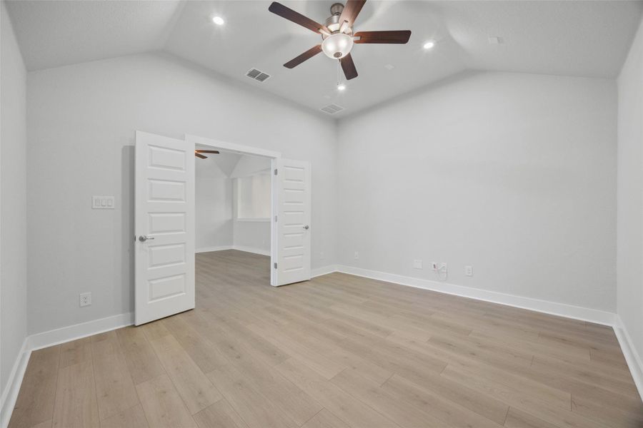 Vast ceilings elevate this airy interior space, complete with sleek flooring and inviting entryways.