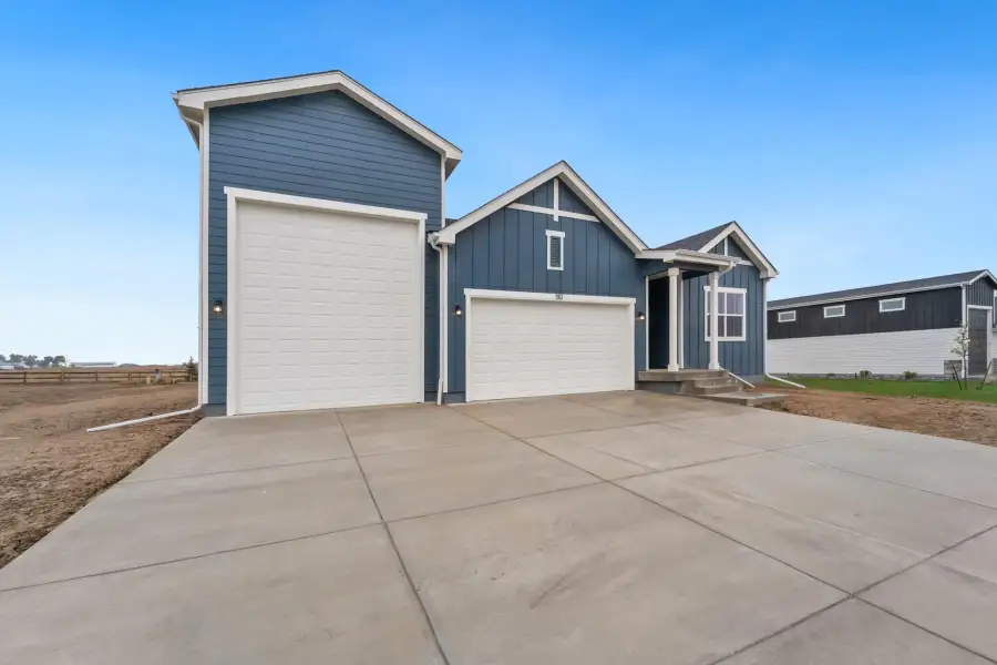 Front exterior of a new home in Hudson Hills, Hudson, CO, highlighting curb appeal (Image 21).