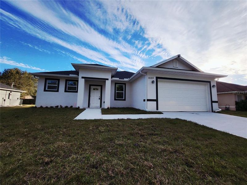 Front exterior of a new home in , Palm Bay, FL, highlighting curb appeal (Image 1). Front exterior of a new home in , Palm Bay, FL, highlighting curb appeal (Image 1).