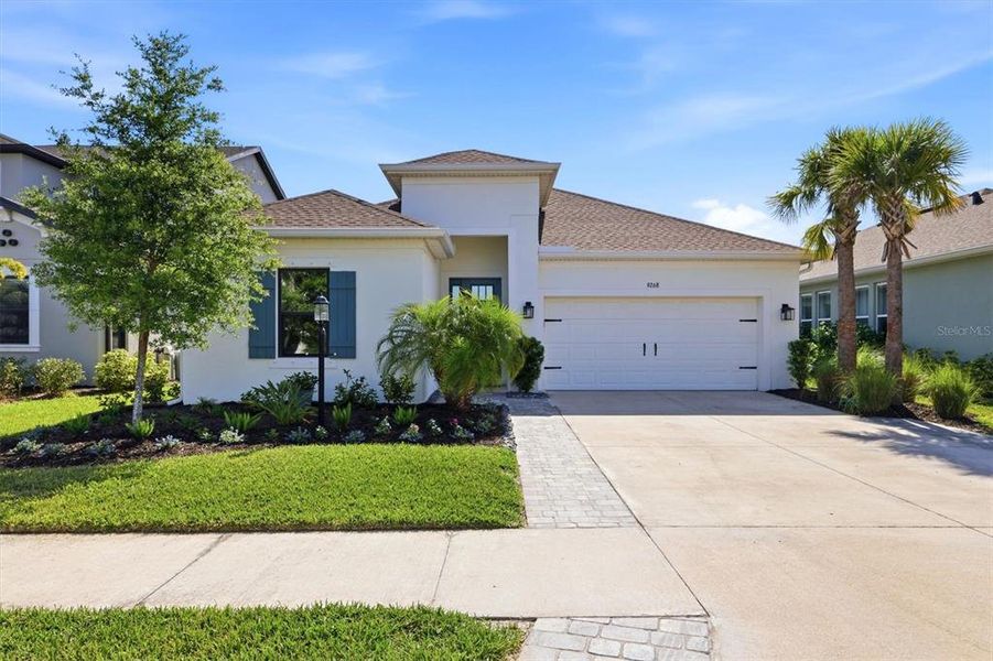 Front exterior of a new home in Skye Ranch Community Group Page, Sarasota, FL, highlighting curb appeal (Image 22).