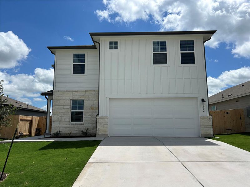 Front exterior of a new home in Eastern Wells, Jarrell, TX, highlighting curb appeal (Image 11). Front exterior of a new home in Eastern Wells, Jarrell, TX, highlighting curb appeal (Image 11).