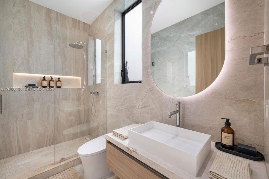 Guest Bathroom. Disclaimer: Several photographs presented in this listing contain digitally added furniture, artwork, and decor. These virtually staged images are intended solely for illustrative purposes.