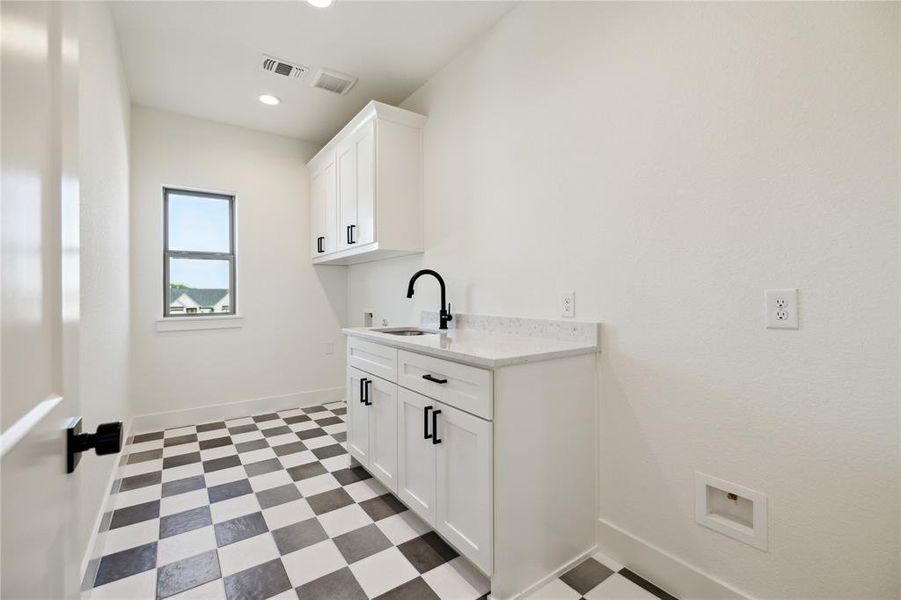 Laundry area with cabinets and sink