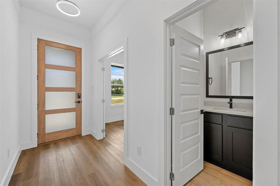 Corridor featuring light hardwood / wood-style floors and sink