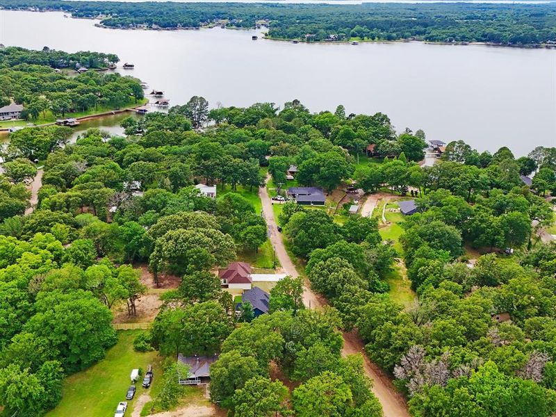 Expansive waterfront property featuring mature trees and multiple structures Expansive waterfront property featuring mature trees and multiple structures