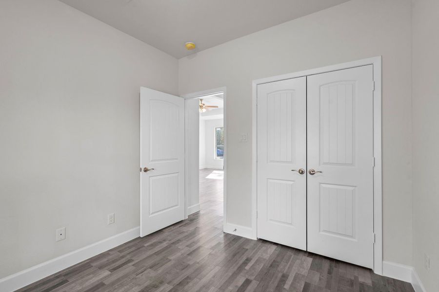This bedroom is complete with a built-in closet.