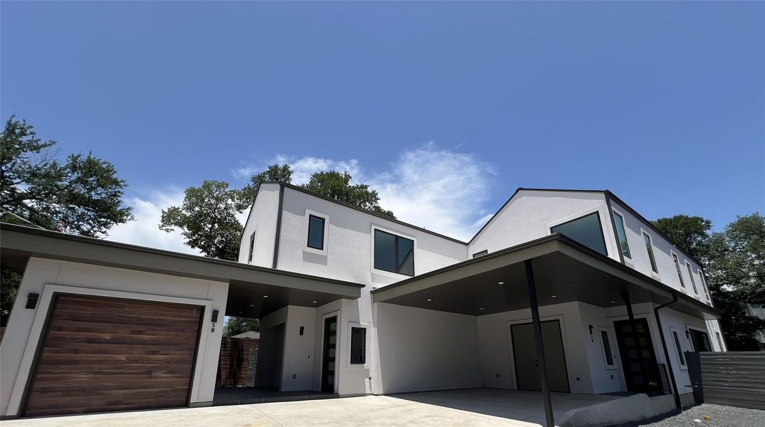 Contemporary house with stucco siding and concrete driveway