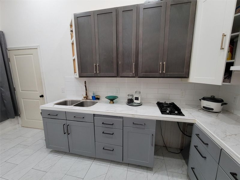 Functional full bathroom and laundry combination featuring a contemporary vanity and convenient washer/dryer hookups. Functional full bathroom and laundry combination featuring a contemporary vanity and convenient washer/dryer hookups.
