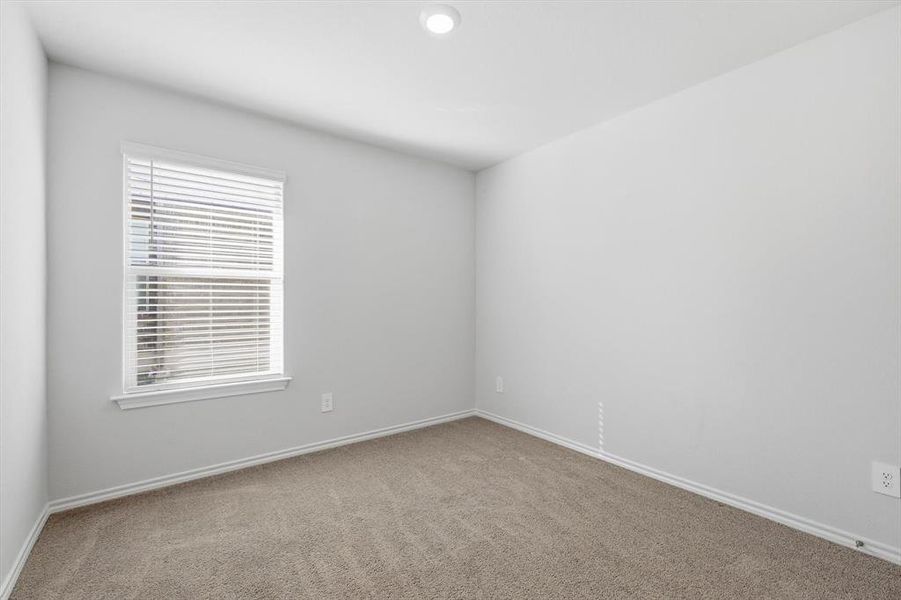 Bedroom 3 with carpet and window Bedroom 3 with carpet and window
