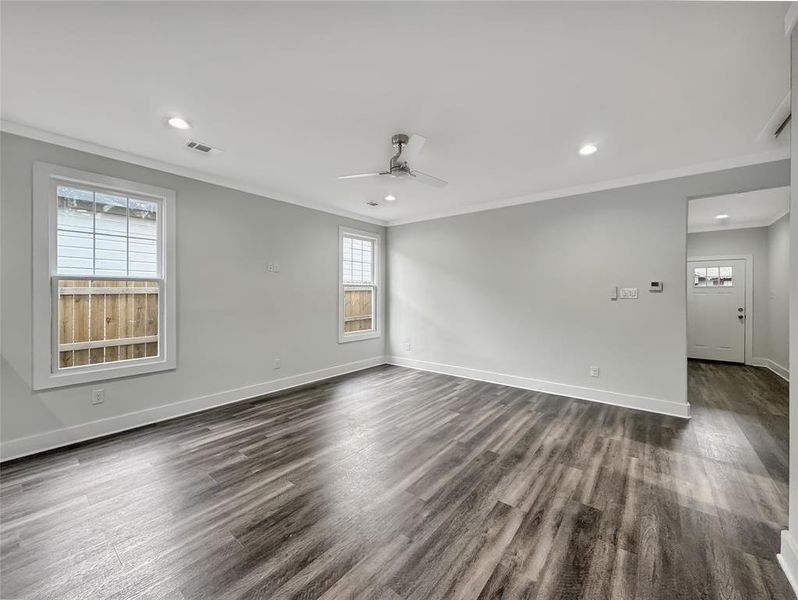 Unfurnished room featuring ceiling fan, crown molding, recessed lighting, and dark wood-style floors Unfurnished room featuring ceiling fan, crown molding, recessed lighting, and dark wood-style floors