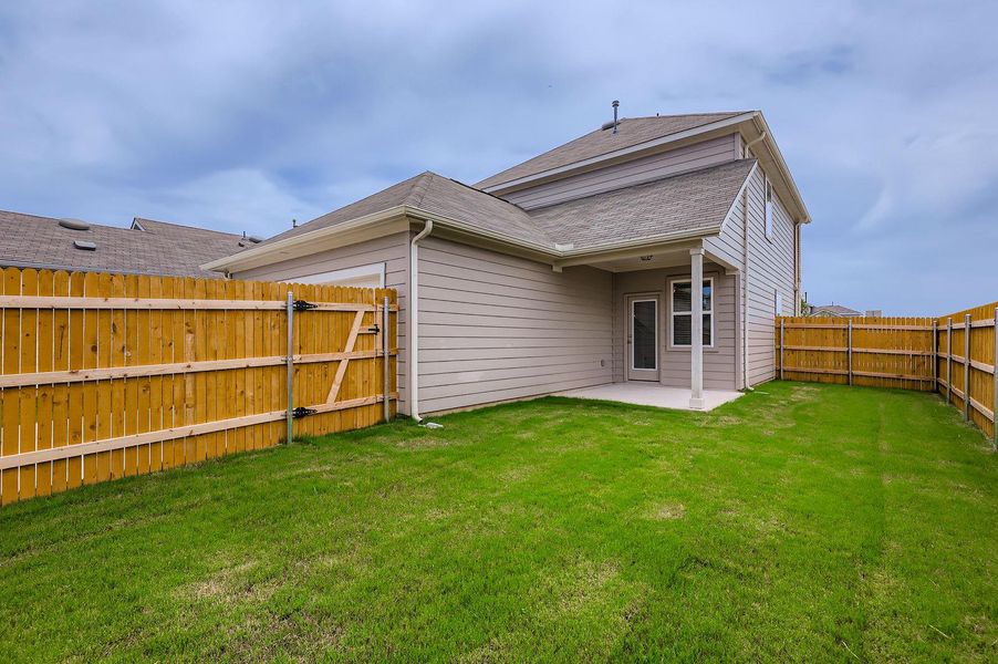 Rear view of house with a patio, a fenced backyard, a shingled roof, and a gate Rear view of house with a patio, a fenced backyard, a shingled roof, and a gate