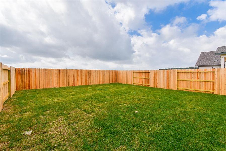 The sturdy wooden fence encloses the space, offering privacy and security. The sturdy wooden fence encloses the space, offering privacy and security.