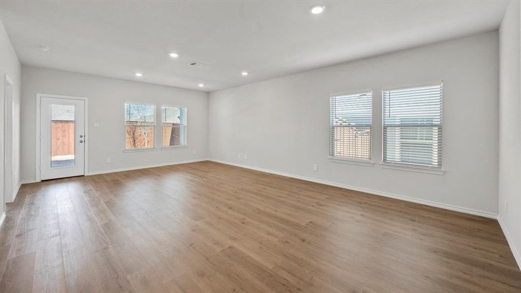 Unfurnished room featuring wood finished floors and recessed lighting