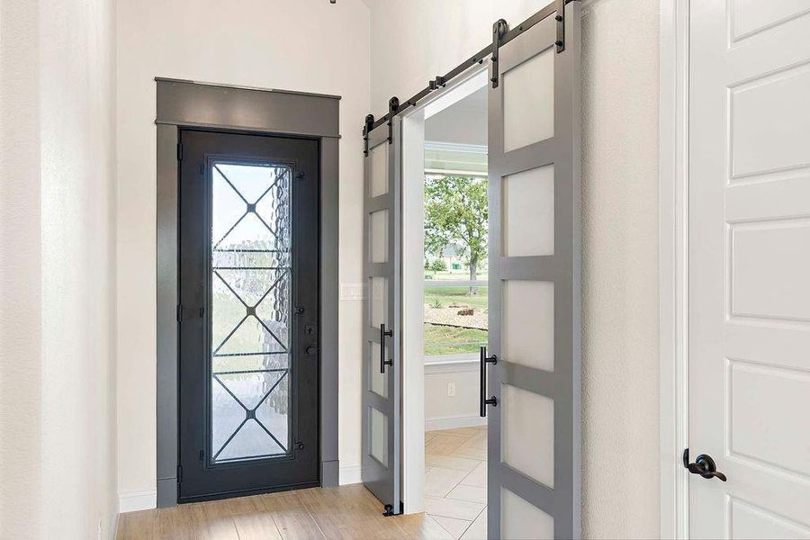 Doorway featuring a barn door and wood finished floors