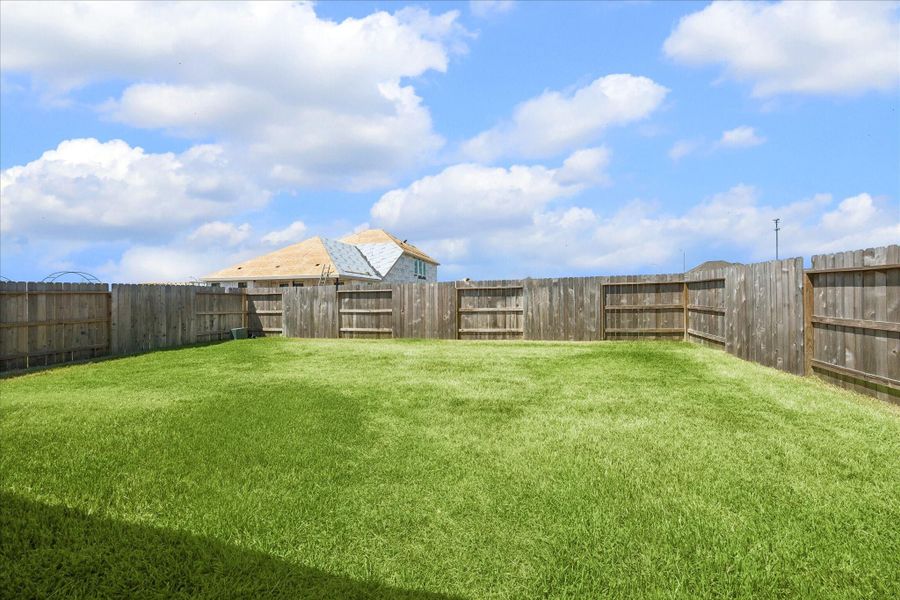Bring on the backyard plans. This fully fenced yard offers plenty of room for playtime, pets, gardening or a future outdoor living setup, with a wide open lawn ready to make your own.