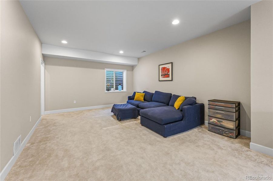 Living Room: Expansive space for entertainment or recreation.