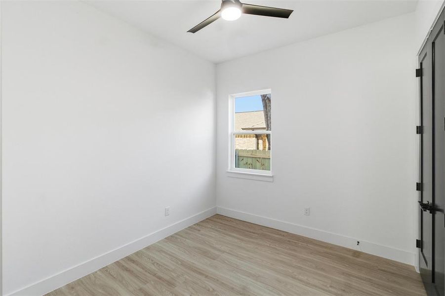 Unfurnished room featuring light wood-type flooring and ceiling fan
