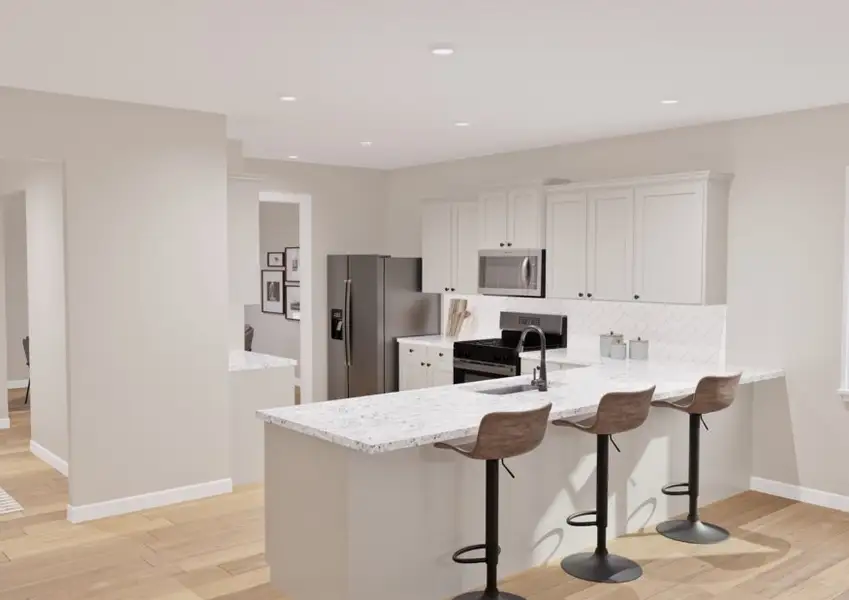 Modern kitchen with white cabinets, herringbone tile backsplash, stainless steel fridge, and oven. White counter with three brown chairs. Bright window and neutral tones.