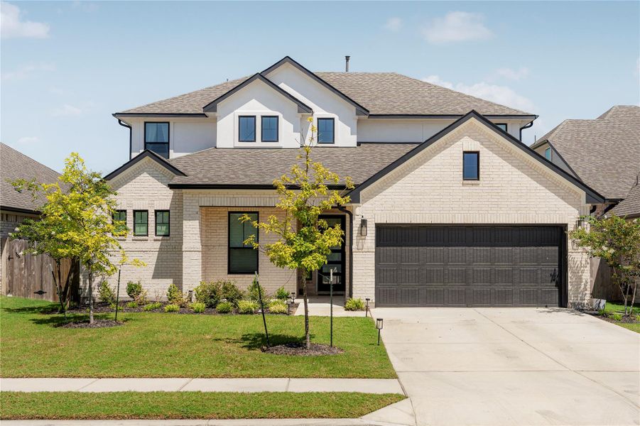 A striking contemporary residence boasts a bright brick exterior and an attached garage. A striking contemporary residence boasts a bright brick exterior and an attached garage.
