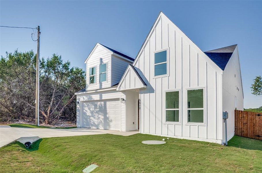 Modern inspired farmhouse featuring board and batten siding, concrete driveway, an attached garage, and a shingled roof Modern inspired farmhouse featuring board and batten siding, concrete driveway, an attached garage, and a shingled roof