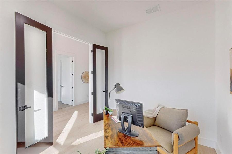 Sitting room featuring french doors and light hardwood / wood-style flooring