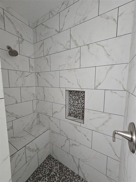 Bathroom featuring tiled shower