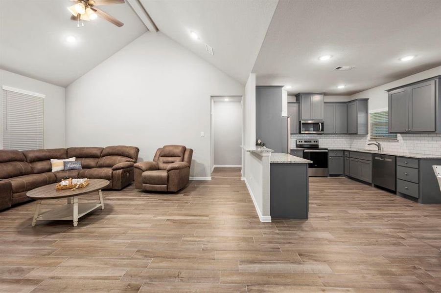 You will love the openness between the family room, kitchen and dining area. Perfect floor plan for family gatherings and entertaining guests. A glimpse of the stunning kitchen with breakfast bar.