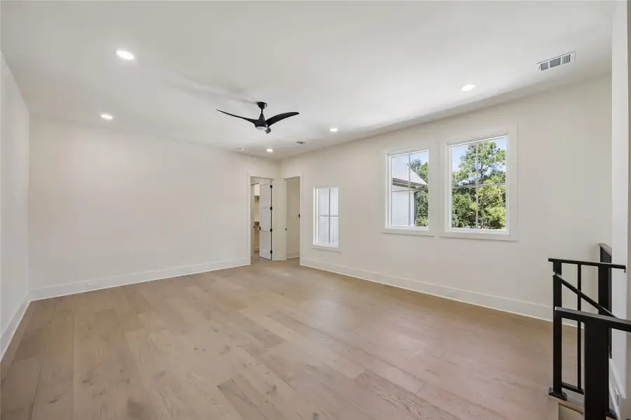 GAMEROOM: Bright and expansive upstairs game room offers flexible living space with abundant natural light and wide plank wood flooring.