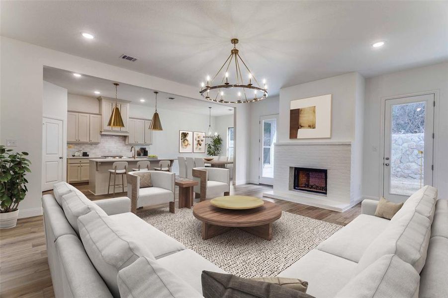 Living area featuring a chandelier, light wood-type flooring, plenty of natural light, recessed lighting, and baseboards Living area featuring a chandelier, light wood-type flooring, plenty of natural light, recessed lighting, and baseboards