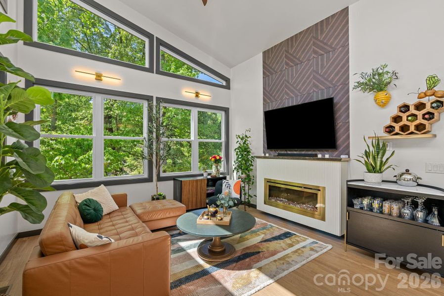 The vaulted ceilings in the open living space creates a sense of space while the cozy fireplace anchors the room.