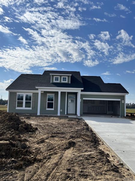 View of front facade with concrete driveway, a porch, a garage, and roof with shingles