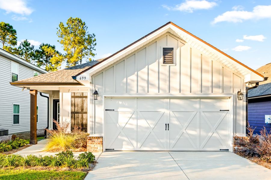 Front exterior of a new home in Crescent and Symphony at Hammock Bay, Freeport, FL, highlighting curb appeal (Image 16). Front exterior of a new home in Crescent and Symphony at Hammock Bay, Freeport, FL, highlighting curb appeal (Image 16).