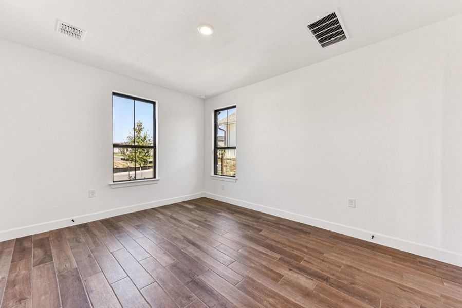 Spare room with dark wood-style flooring and recessed lighting