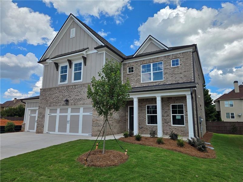 Front exterior of a new home in Pinecrest Ridge, Dacula, GA, highlighting curb appeal (Image 25). Front exterior of a new home in Pinecrest Ridge, Dacula, GA, highlighting curb appeal (Image 25).