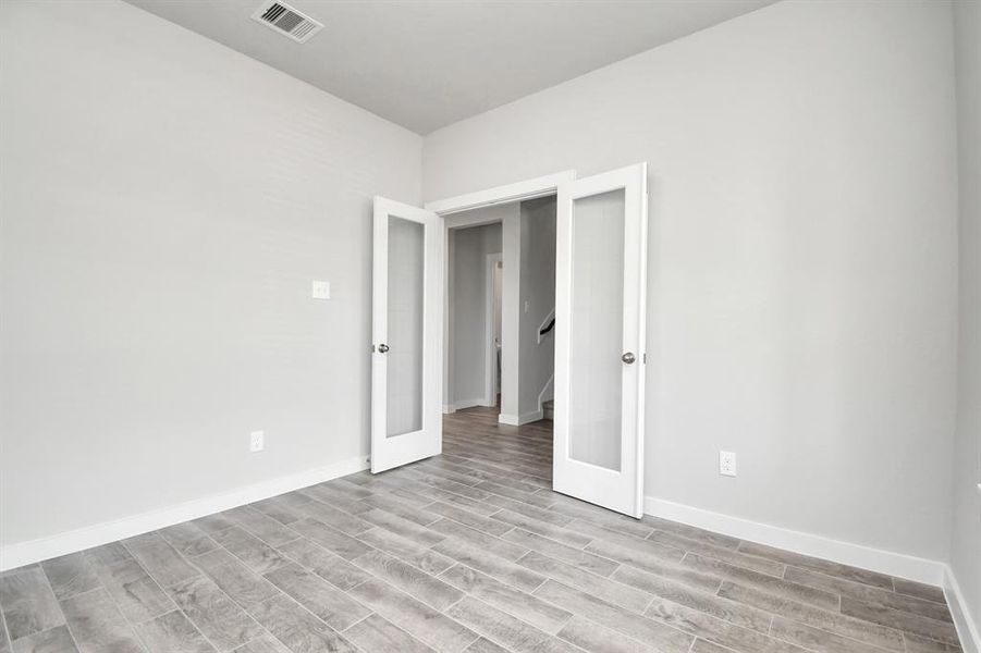 Another view of the home office, with French doors,  at the forefront of the home.