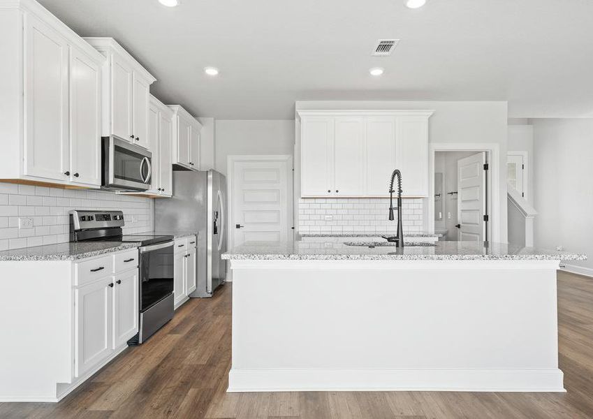 Another fantastic view of the kitchen featuring the expansive island.