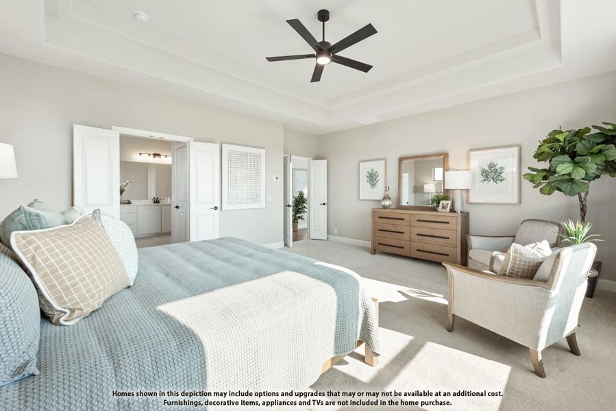Master bedroom with tray ceiling, ceiling fan, carpet floors, and open door to ensuite bathroom Master bedroom with tray ceiling, ceiling fan, carpet floors, and open door to ensuite bathroom