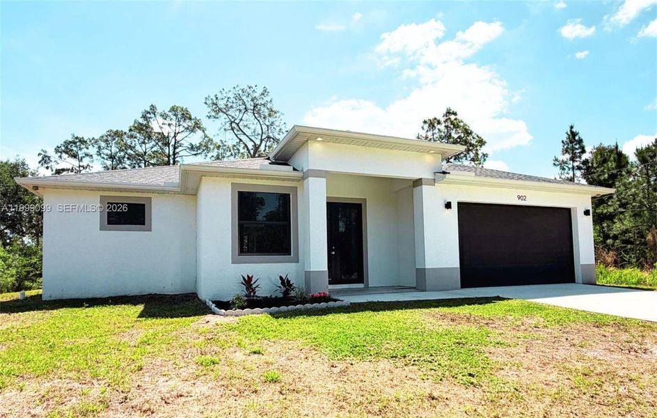 Front exterior of a new home in , Lehigh Acres, FL, highlighting curb appeal (Image 26). Front exterior of a new home in , Lehigh Acres, FL, highlighting curb appeal (Image 26).