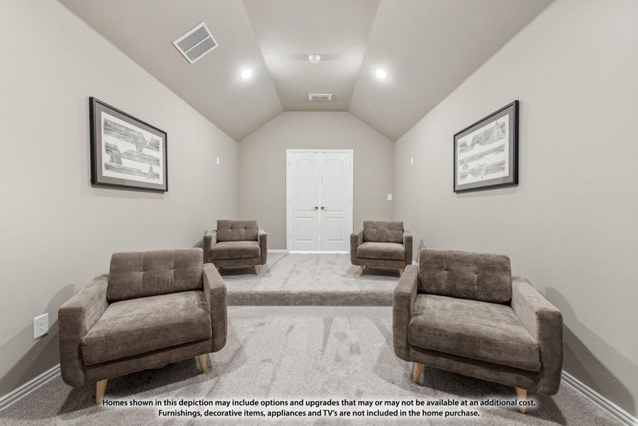 Bonus room with vaulted ceiling, four armchairs, carpet flooring, and framed wall art Bonus room with vaulted ceiling, four armchairs, carpet flooring, and framed wall art