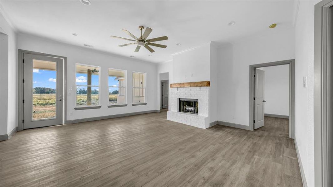 Living room with plenty of natural light & a wood burning fireplace!