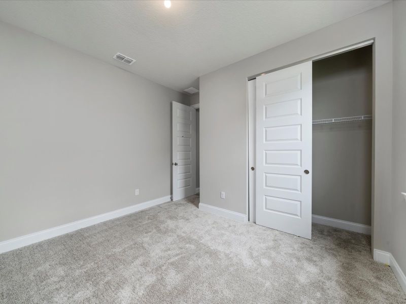 Bedroom in the Coral floorplan at 6295 NW Sweetwood Drive in Brystol at Wylder