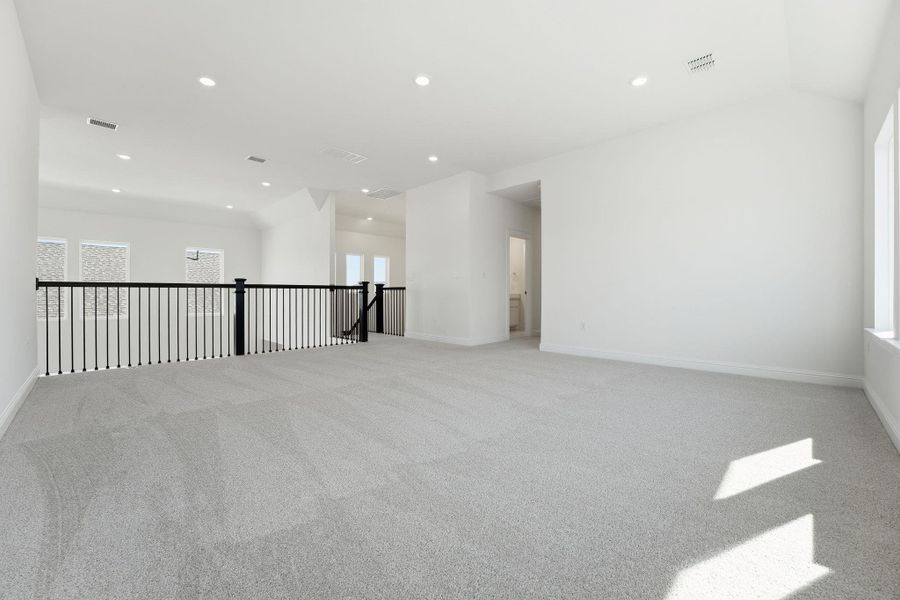 Empty room featuring light colored carpet and recessed lighting