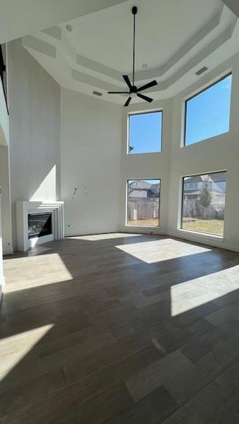The architecture and coffered high ceilings make this huge living area a room to marvel. Large windows cover the back wall for loads of natural light. A beautiful Madrid fireplace will add warmth and a cozy atmosphere on a cool winter evening.