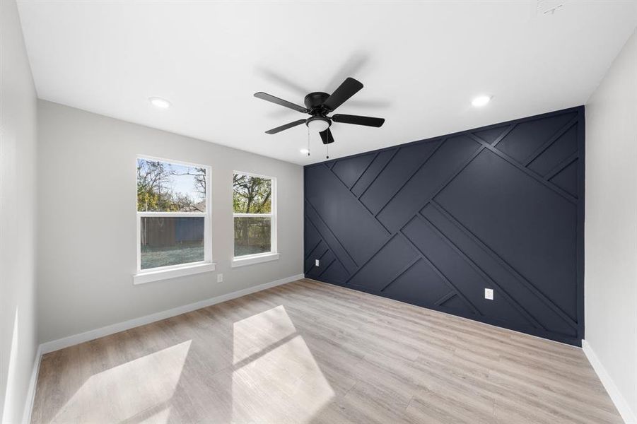 Spare room featuring an accent wall, ceiling fan, wood finished floors, a decorative wall, and recessed lighting Spare room featuring an accent wall, ceiling fan, wood finished floors, a decorative wall, and recessed lighting