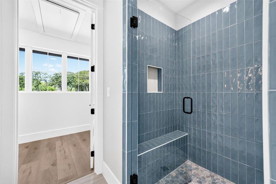 Oversized custom walk-in shower showcasing spectacular tile work, a built-in seating bench and seamless glass enclosure. Oversized custom walk-in shower showcasing spectacular tile work, a built-in seating bench and seamless glass enclosure.