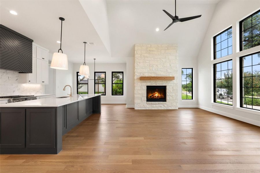 A striking fireplace with a rustic wood mantel commands attention in this inviting great room.